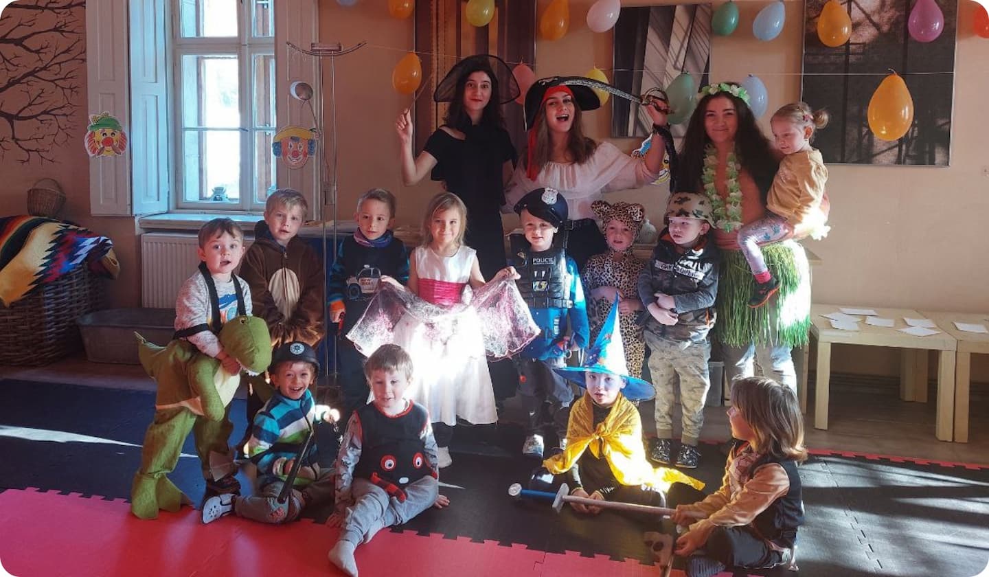 depicted volunteers surrounded by children at a costume party